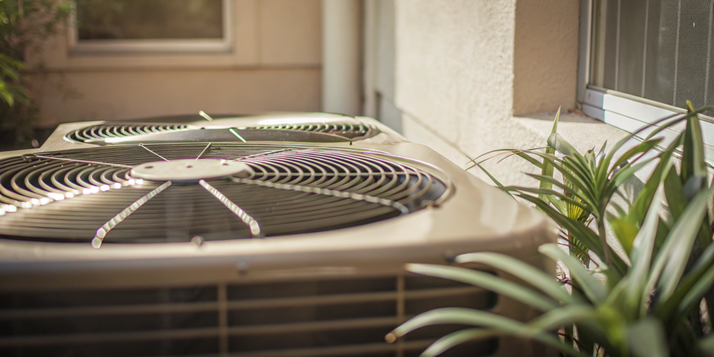 The compressor in an outdoor AC unit, a major factor in replacement cost.